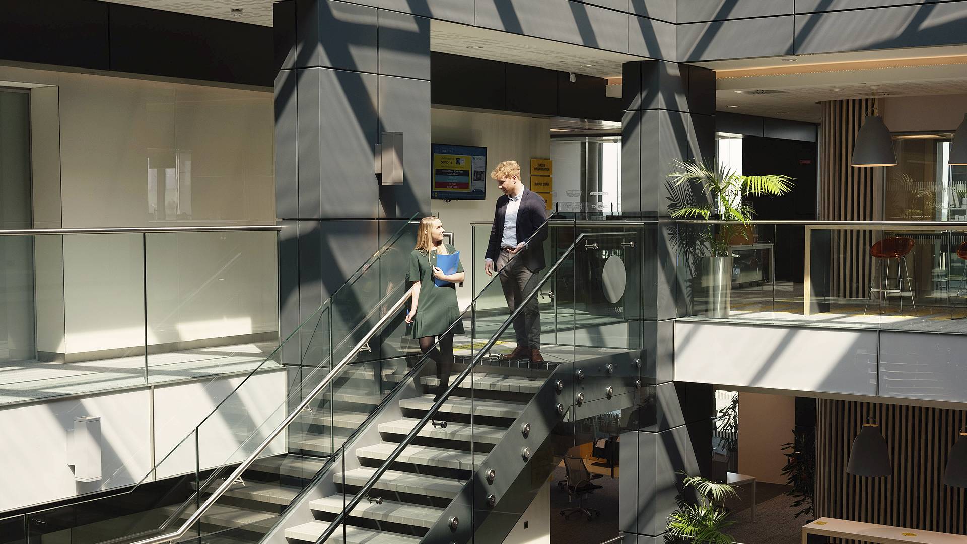 Office - two people walking down stairs
